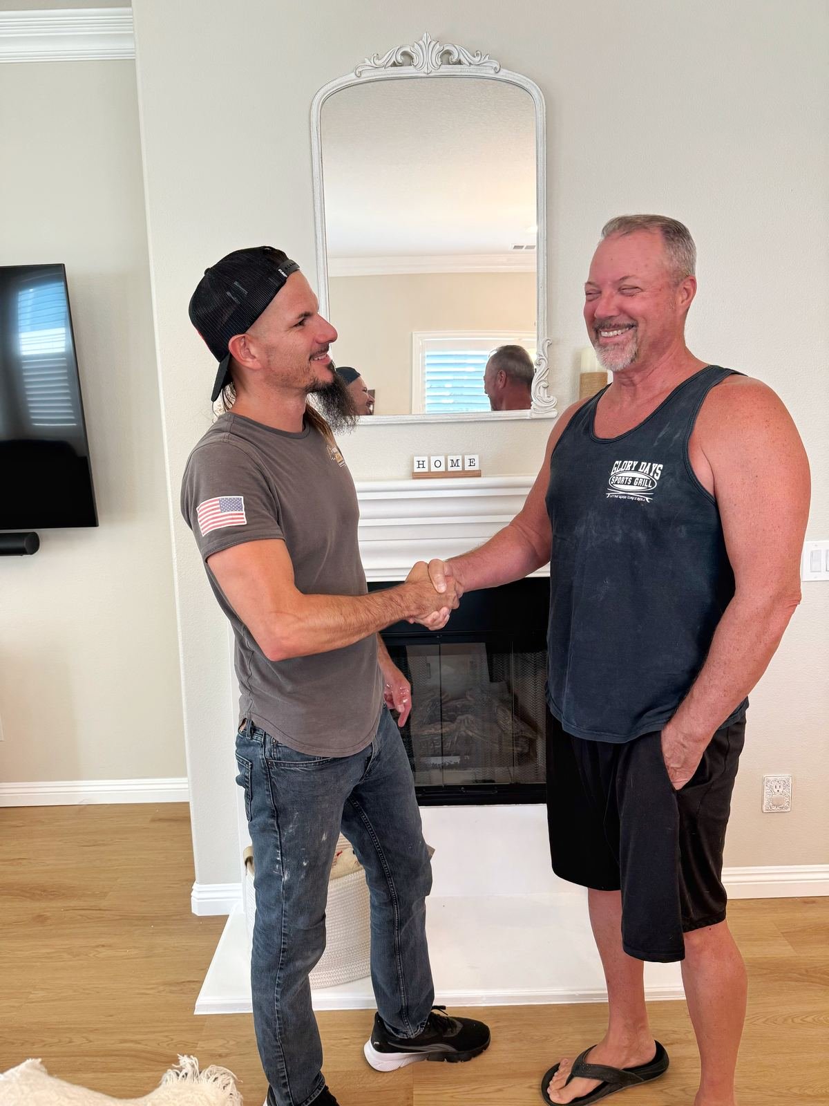 Rob with a client after finishing a fireplace remodel