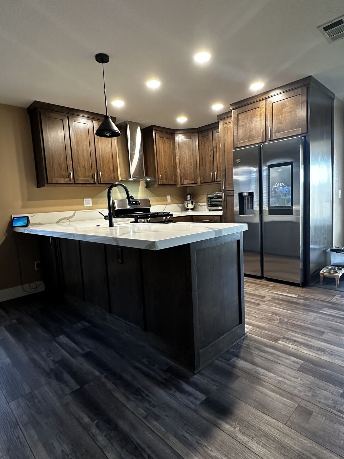 Modern stone-inspired kitchen after remodel with stainless appliances