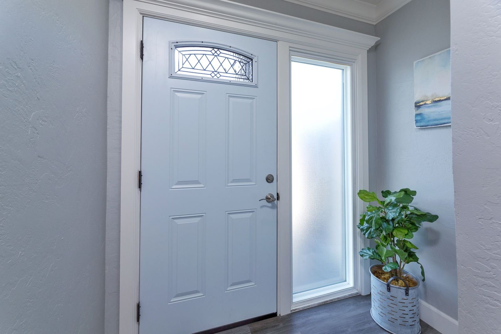 New white front door with leaded glass insert after installation